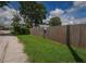 Fenced backyard with lush greenery along the perimeter, offering privacy and a natural aesthetic appeal at 358 51St N Ave, St Petersburg, FL 33703