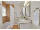 Bathroom featuring tub and shower, granite vanity, updated lighting, and tiled shower at 358 51St N Ave, St Petersburg, FL 33703