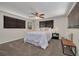 This bedroom is warm and inviting with large windows, ceiling fan, plush carpeting, and stylish decor at 358 51St N Ave, St Petersburg, FL 33703