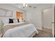 Cozy bedroom featuring plush carpet, a window with blinds, and ample natural light at 358 51St N Ave, St Petersburg, FL 33703