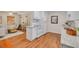 Bright kitchen featuring modern white appliances, granite countertops, and wood floors at 358 51St N Ave, St Petersburg, FL 33703