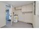 Laundry room with water heater, cabinets for storage, and a gray floor at 358 51St N Ave, St Petersburg, FL 33703