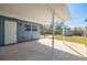 Covered patio with concrete flooring overlooks the landscaped backyard and provides an area for outdoor enjoyment and relaxation at 358 51St N Ave, St Petersburg, FL 33703