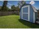 Backyard shed with white trim offers practical storage solutions and compliments the lush, green landscape at 358 51St N Ave, St Petersburg, FL 33703