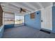 Sun room with blue walls, a ceiling fan, carpet and large windows for plenty of light at 358 51St N Ave, St Petersburg, FL 33703