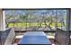 A cozy balcony with a table set offers a view of a serene landscaped park at 36750 Us Highway 19 N # 19308, Palm Harbor, FL 34684
