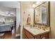 Stylish bathroom vanity with granite countertop, wood cabinet, and view of the bedroom at 36750 Us Highway 19 N # 19308, Palm Harbor, FL 34684
