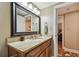 Traditional bathroom vanity featuring granite countertops, dark wood cabinets, and a large mirror at 36750 Us Highway 19 N # 19308, Palm Harbor, FL 34684