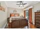 Comfortable bedroom with decorative headboard, ceiling fan, and sliding door access to outdoor space with natural light at 36750 Us Highway 19 N # 19308, Palm Harbor, FL 34684