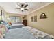Comfortable bedroom with two beds, wood floors, and neutral wall color at 36750 Us Highway 19 N # 19308, Palm Harbor, FL 34684