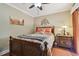 Cozy bedroom featuring natural light, decorative headboard, and ceiling fan to provide a relaxing ambiance at 36750 Us Highway 19 N # 19308, Palm Harbor, FL 34684