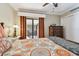 Bright bedroom with sliding glass doors to a balcony, stylish bedding, and a cozy ambiance for relaxation at 36750 Us Highway 19 N # 19308, Palm Harbor, FL 34684