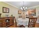 Lovely dining room adjacent to the kitchen with seating for four and a stylish server cabinet at 36750 Us Highway 19 N # 19308, Palm Harbor, FL 34684