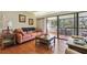 Relaxing living room featuring a comfortable couch, hardwood floors, and a sliding glass door leading to the balcony at 36750 Us Highway 19 N # 19308, Palm Harbor, FL 34684