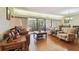 Bright living room with hardwood floors, comfortable seating, and access to a balcony overlooking the landscape at 36750 Us Highway 19 N # 19308, Palm Harbor, FL 34684