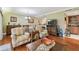 Comfortable living space featuring wood floors, inviting armchairs, and seamless flow to the dining area and kitchen at 36750 Us Highway 19 N # 19308, Palm Harbor, FL 34684