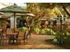 Outdoor dining area with tables and chairs surrounded by lush greenery, offering a relaxing atmosphere at 36750 Us Highway 19 N # 19308, Palm Harbor, FL 34684