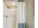 Bright bathroom shower featuring white tiling and a decorative dragonfly shower curtain at 36750 Us Highway 19 N # 19308, Palm Harbor, FL 34684