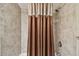 Tiled shower with a rainfall shower head and decorative shower curtain at 36750 Us Highway 19 N # 19308, Palm Harbor, FL 34684