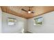 Bright bedroom with wood plank ceiling, neutral walls, hardwood-style flooring, and natural light at 4009 W Mango Ave, Tampa, FL 33616