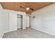 Bright bedroom features a light gray wall, closet with white doors, and plank flooring at 4009 W Mango Ave, Tampa, FL 33616