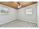 Comfortable bedroom featuring wood plank ceiling, fan, hardwood-style floors, and natural light at 4009 W Mango Ave, Tampa, FL 33616