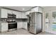 Modern kitchen with stainless steel appliances, white cabinetry, and a stylish backsplash at 4009 W Mango Ave, Tampa, FL 33616