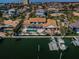Aerial view showcasing waterfront home, a private pool, lush landscaping, and a private dock at 4998 62Nd S Ave, St Petersburg, FL 33715