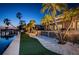 Beautiful waterfront backyard at dusk featuring lush landscaping, and a patio area at 4998 62Nd S Ave, St Petersburg, FL 33715