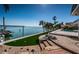 Landscaped backyard features access to the bay, an artificial lawn, and a private dock at 4998 62Nd S Ave, St Petersburg, FL 33715