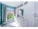 This bathroom features a full wall of storage, bright countertops, and a window providing natural light at 4998 62Nd S Ave, St Petersburg, FL 33715