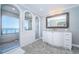 Bright bathroom featuring arched doorways, glass shower, and water views at 4998 62Nd S Ave, St Petersburg, FL 33715