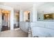 This elegant bathroom boasts a soaking tub, walk-in shower, and custom vanity with stone counters and mirrors at 4998 62Nd S Ave, St Petersburg, FL 33715
