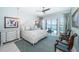 This stylish bedroom features great views of the water, a decorative bed, and plenty of lighting at 4998 62Nd S Ave, St Petersburg, FL 33715