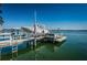 The boat sits on a platform above the water attached to the dock on a sunny day at 4998 62Nd S Ave, St Petersburg, FL 33715