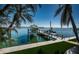 Boat on a lift on a calm waterfront with well-manicured landscaping at 4998 62Nd S Ave, St Petersburg, FL 33715