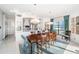 Bright dining area featuring elegant wooden table, seating, and views of the water and surrounding scenery at 4998 62Nd S Ave, St Petersburg, FL 33715