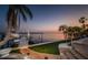 This waterfront property includes a private boat dock with a boat lift surrounded by tropical landscaping at 4998 62Nd S Ave, St Petersburg, FL 33715