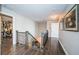 This hallway features hardwood floors, custom railings, and plenty of natural light at 4998 62Nd S Ave, St Petersburg, FL 33715