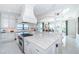 Spacious, all-white kitchen features a large island and stainless steel appliances, offering a chef-inspired design at 4998 62Nd S Ave, St Petersburg, FL 33715