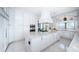 Bright, white kitchen with an island, stainless steel appliances, and luxurious countertops offers a sleek design at 4998 62Nd S Ave, St Petersburg, FL 33715