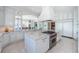 Spacious, all-white kitchen boasts a large island, stainless steel range, and access to the breakfast nook at 4998 62Nd S Ave, St Petersburg, FL 33715