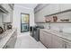 This laundry room offers stainless steel appliances, stone countertops, and custom cabinetry at 4998 62Nd S Ave, St Petersburg, FL 33715