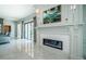 Living room boasts a fireplace, modern decor, and seamless access to the outdoors through sliding doors at 4998 62Nd S Ave, St Petersburg, FL 33715