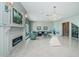 Inviting living room with a fireplace, modern chandelier, sleek table and comfortable seating at 4998 62Nd S Ave, St Petersburg, FL 33715