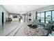 Expansive living room with modern fireplace, comfortable seating, and water views through large windows at 4998 62Nd S Ave, St Petersburg, FL 33715