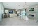 Open-concept living room featuring a fireplace, large windows, modern lighting, and comfortable seating at 4998 62Nd S Ave, St Petersburg, FL 33715