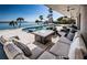 This outdoor living area features an outdoor pool, outdoor furniture, and an outdoor fire pit overlooking the water at 4998 62Nd S Ave, St Petersburg, FL 33715