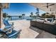 This outdoor living area features an outdoor pool, outdoor furniture and lush landscaping overlooking the water at 4998 62Nd S Ave, St Petersburg, FL 33715