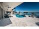 Backyard pool features in-pool lounging and panoramic bay views in this luxurious outdoor living space at 4998 62Nd S Ave, St Petersburg, FL 33715